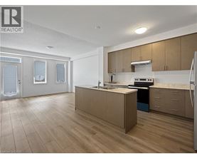 A kitchen with wooden floors and a refrigerator.