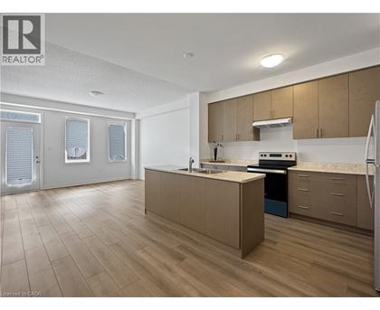 A kitchen with wooden floors and a refrigerator.
