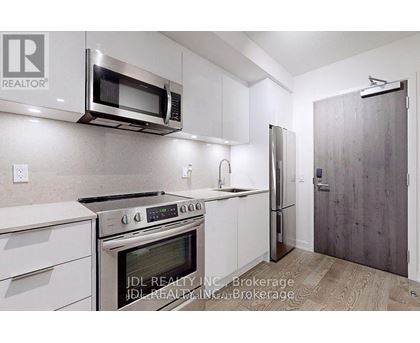 A kitchen with white cabinets and stainless steel appliances.