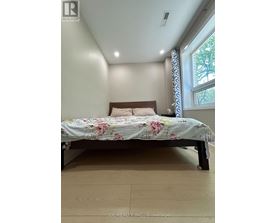 A bedroom with a bed and a window.
