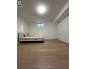 A bedroom with a bed and a window.