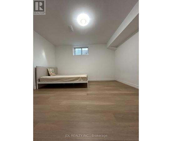 A bedroom with a bed and a window.