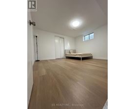 A room with wooden flooring and a bed in Brokerage.