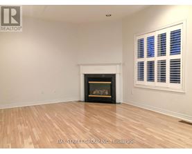 A room with a fireplace and a window with blinds.