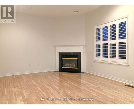 A room with a fireplace and a window with blinds.