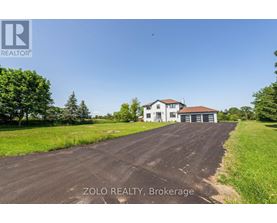 A house with a driveway in front of it is for sale with Zolo Realty in Brokerage.