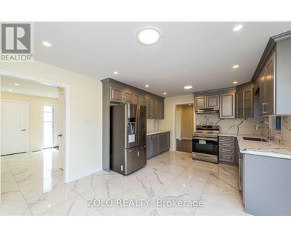 A modern kitchen with a marble floor and a refrigerator with a water dispenser.