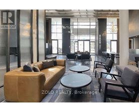 A modern waiting area with a sofa, chairs, and tables.