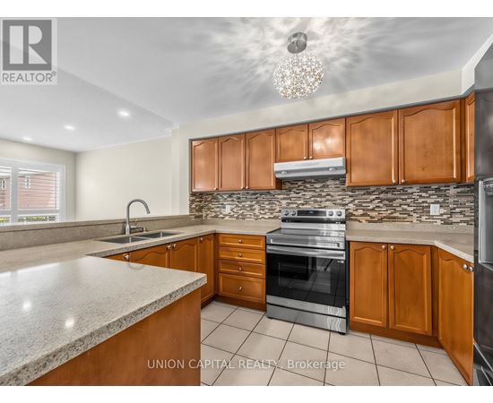 A kitchen with wooden cabinets and a granite countertop.