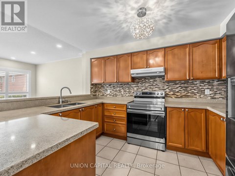 A kitchen with wooden cabinets and a granite countertop.
