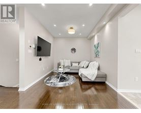 A living room with a grey couch and a white coffee table.