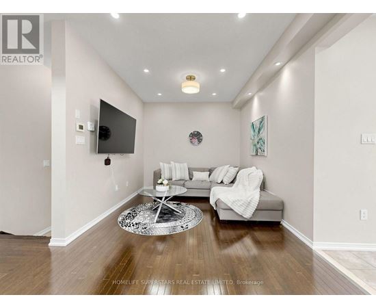 A living room with a grey couch and a white coffee table.