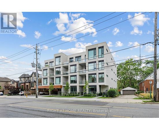 A modern apartment building with a clear sky in the background.