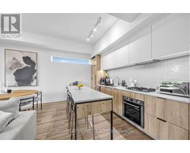A modern kitchen with wooden cabinets and a dining table.
