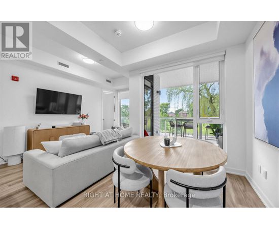 A modern living room with a wooden table and grey couch.