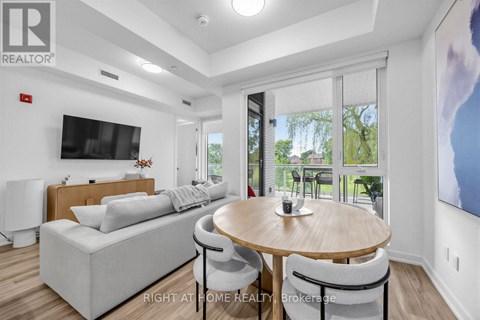 A modern living room with a wooden table and grey couch.