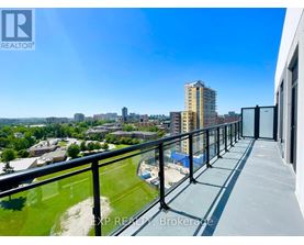 A balcony overlooks a cityscape with buildings and greenery.
