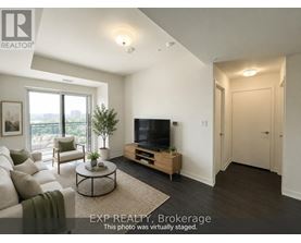A living room with a couch, a coffee table, a television, and a plant.