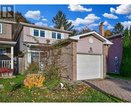 A house with the number 677 on it is for sale.