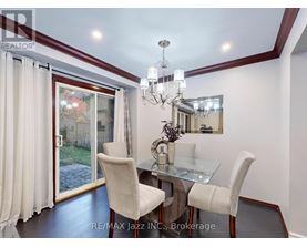 A dining room with a glass table and chairs.