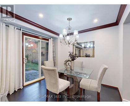 A dining room with a glass table and chairs.