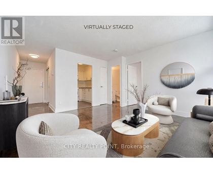 A modern living room with a white chair and a coffee table.