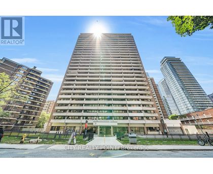 A tall building with a sun shining in the background.