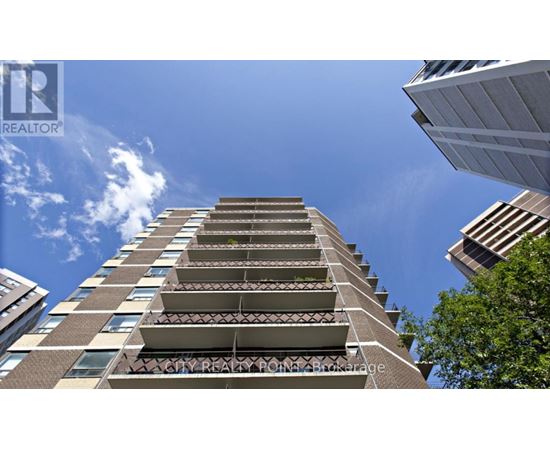 A tall residential building with balconies on the upper floors.