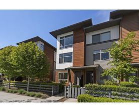 A modern two-story residential building with a brown and white exterior.