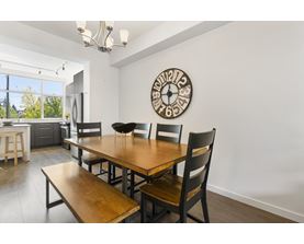 A dining room with a wooden table and chairs.