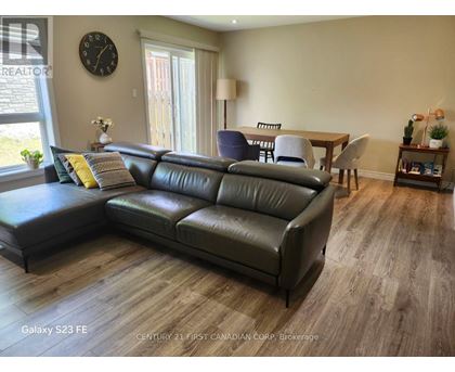 A living room with a leather sofa and a wooden table.