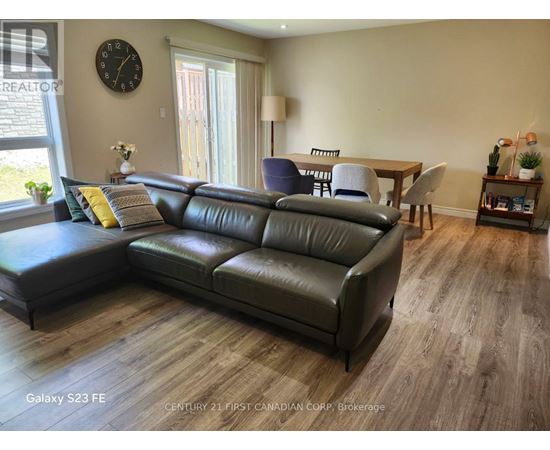 A living room with a leather sofa and a wooden table.