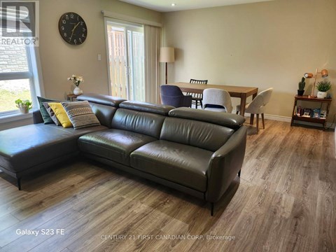 A living room with a leather sofa and a wooden table.