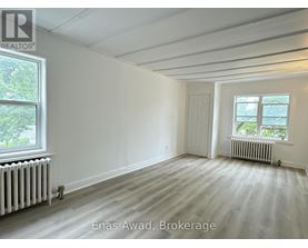A white room with a window and a door.