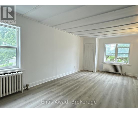 A white room with a window and a door.