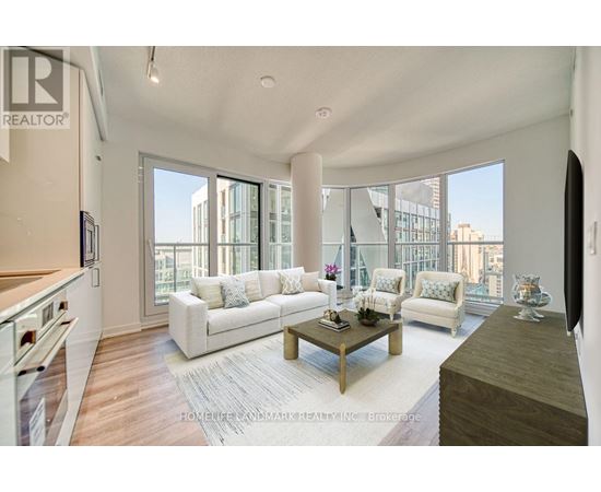 A living room with a white couch and a coffee table.