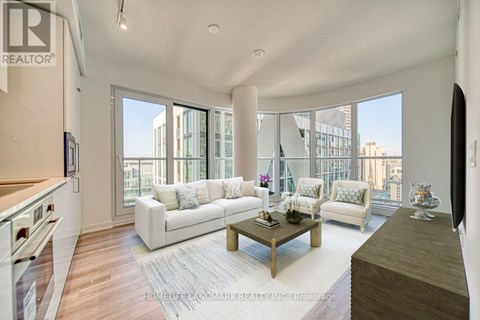 A living room with a white couch and a coffee table.