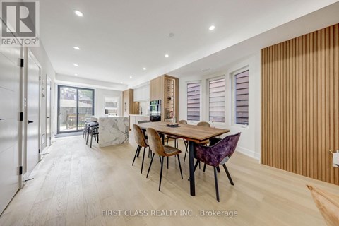 A dining room with a table and chairs is shown in the image.