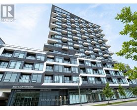A modern building with a glass facade and a sign that reads "RE/MAX Imperial Realty".