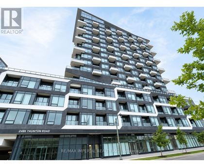 A modern building with a glass facade and a sign that reads "RE/MAX Imperial Realty".