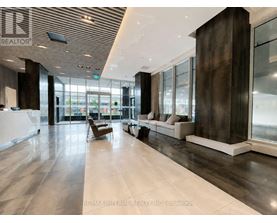 A spacious lobby with a wooden ceiling and marble floors.