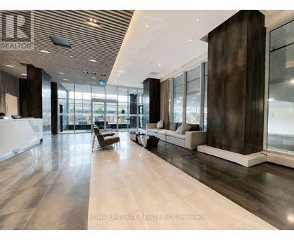A spacious lobby with a wooden ceiling and marble floors.