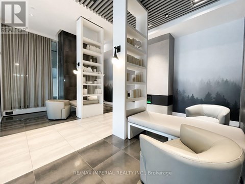 A modern living room with a white sofa and a glass cabinet.