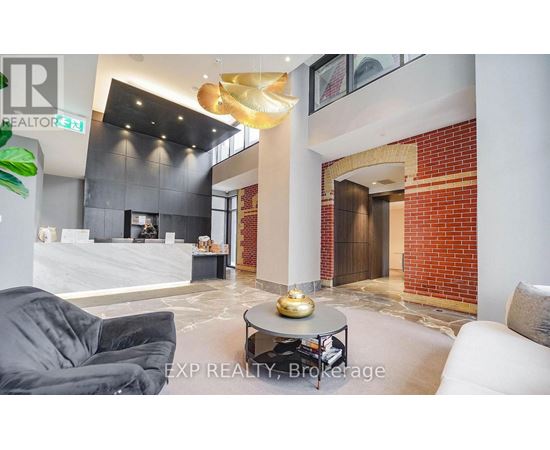 A modern living room with a grey sofa and a coffee table.