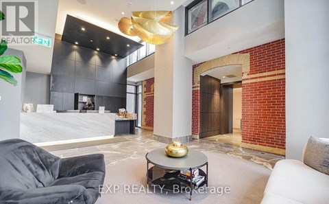 A modern living room with a grey sofa and a coffee table.