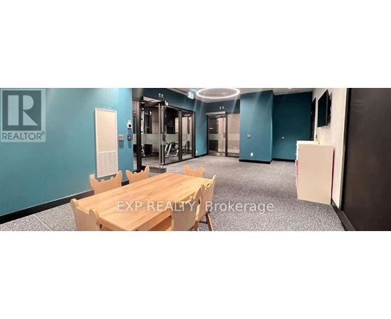 A conference room with a table and chairs and a sign that says EXP REALTY Brokerage.