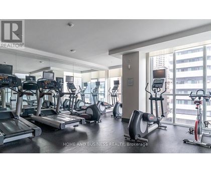 A gym with treadmills, elliptical machines, and other exercise equipment.