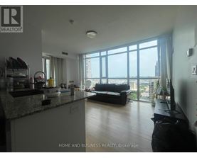 A well-lit kitchen with a view of the city.