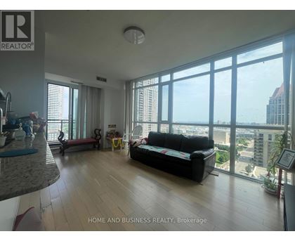 A living room with a couch and a view of the city.