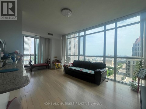 A living room with a couch and a view of the city.